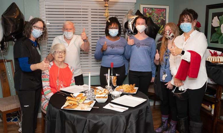 Liz and Kent Hughes with HOV staff and Dream Catchers members at silver anniversary celebration 