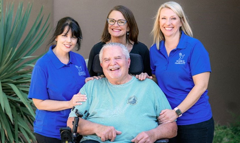 Patient John Rosso posing with his HOV team