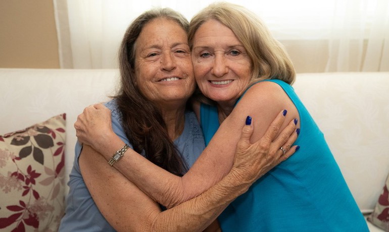 Betty Schecker and Darlene Ferjak embracing