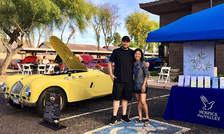 Griffin Perry and Noeleen Rivers standing beside classic car