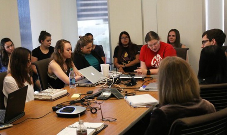 ASU students gathered together at a classroom table 