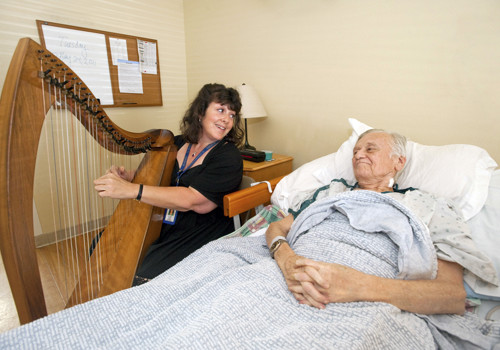 Harpist Joyce Obermeyer playing for patient