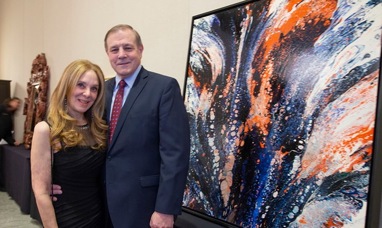 Diane Silver and Jim Condo beside a painting