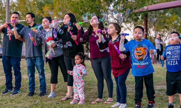 New Song Center families blowing bubbles and event