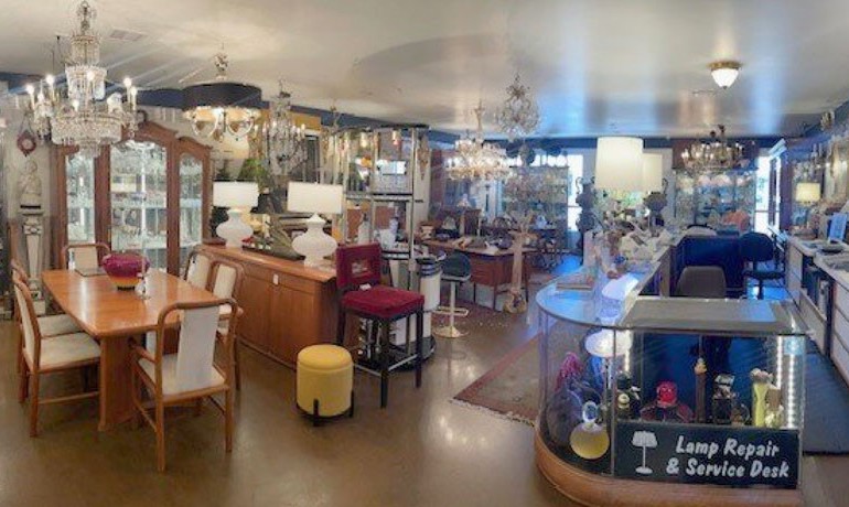 Antique lighting and furniture displayed at the Phoenix Antique Emporium showroom