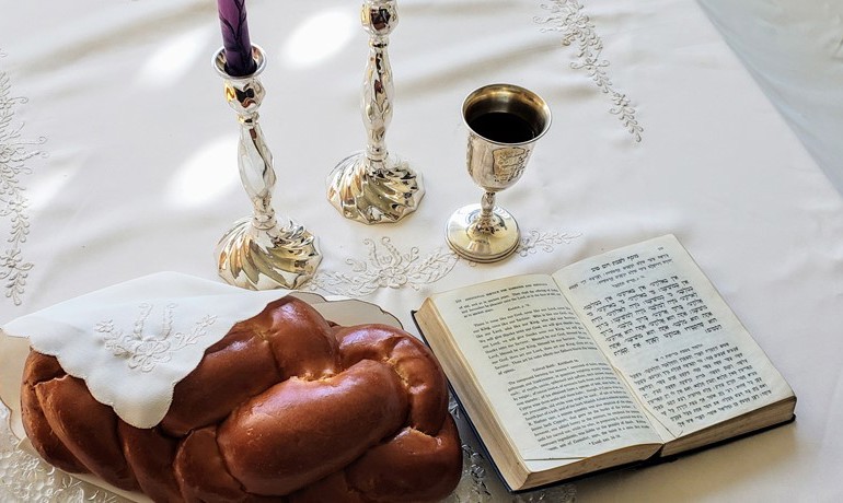 Shabbat blessing with challah, candles, wine and the Tanakh