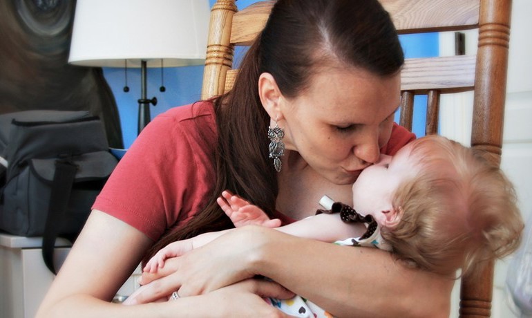 Parent kissing child at Ryan House