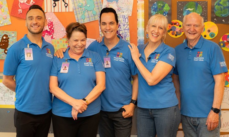 Five members of Partners that Heal smiling together