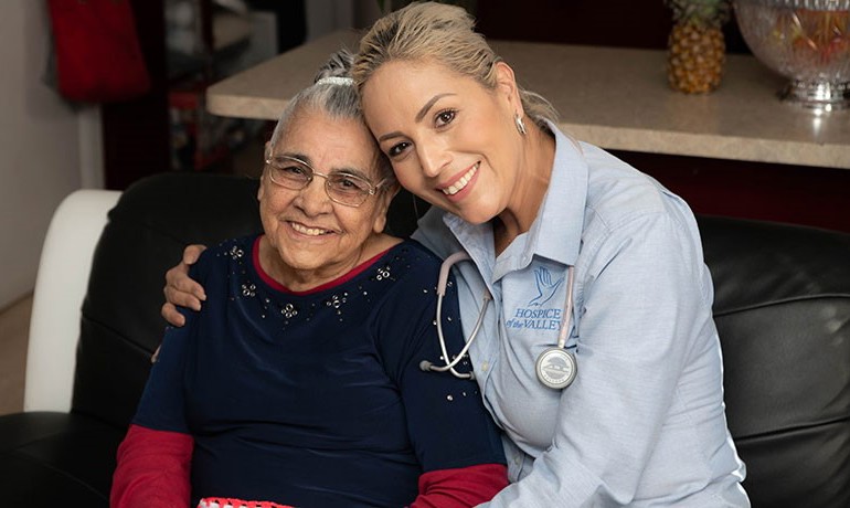 HOV staff member with arm around seated woman