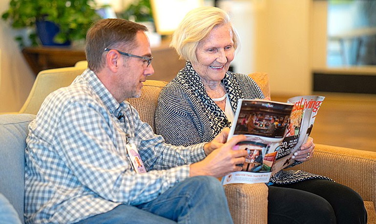 Volunteer reading to patient