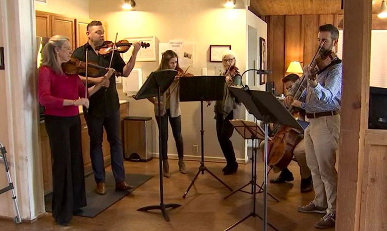 Six string musicians performing at Gardiner Home