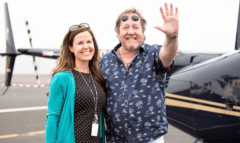 Andrea Toczek and Ron Davis in front of helicopter
