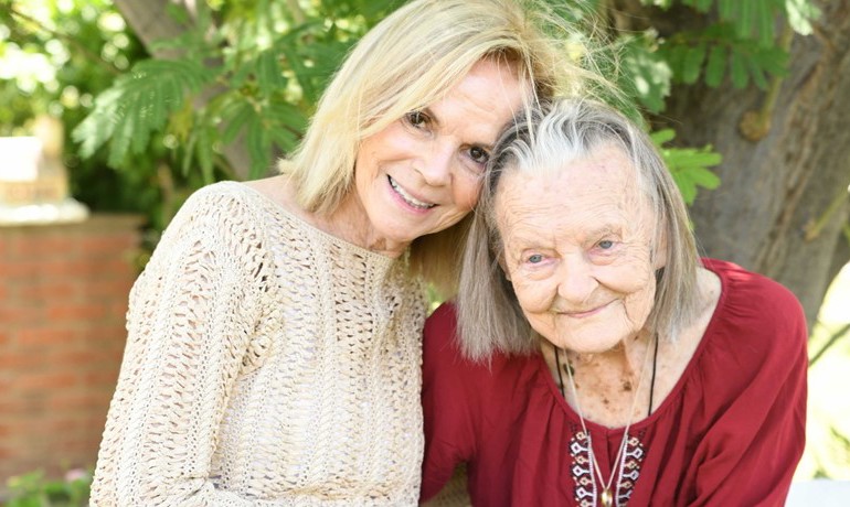Caregiver with patient hugging